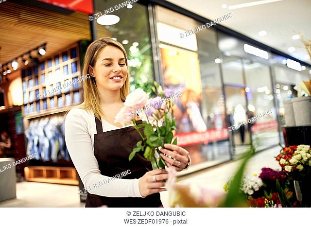 Florist arranging flowers in flower shop