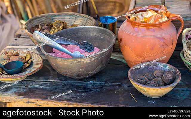 Utensils, handmade dyeing of fabrics and wool in a cauldron with colored dyes in a medieval fair in Spain