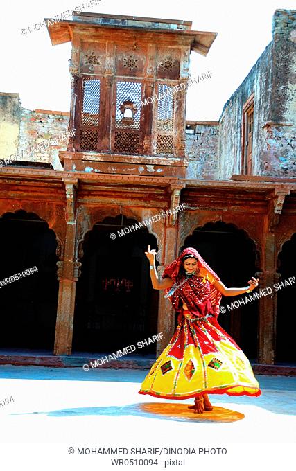 Rajasthani woman performing ghoomer dance in haveli , Rajasthan , India MR769C