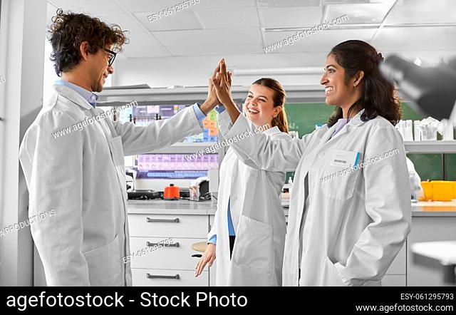 happy international scientists in laboratory