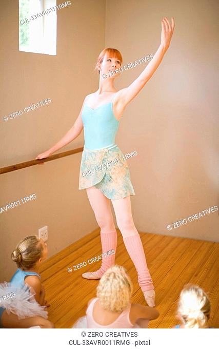 Ballet teacher posing at barre