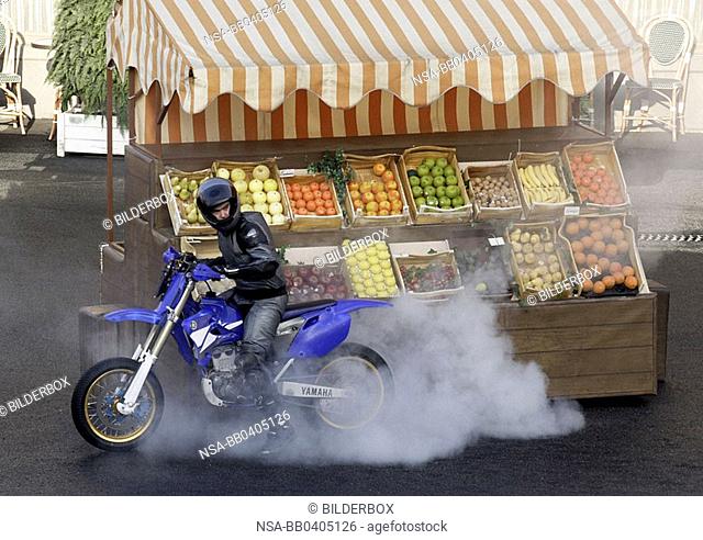 biker infront of a fruitstall