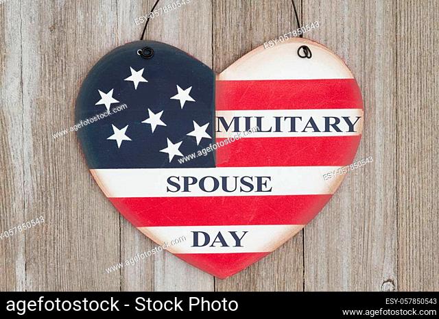 Retro Military Spouse Day heart sign with the colors of the USA flag on weathered wood