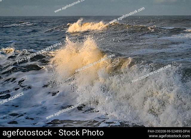 02 February 2023, Denmark, Agger: In the light of the morning sun waves of the North Sea break on the west coast at the National Park Thy