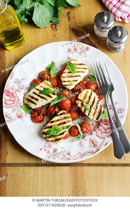Halloumi and cherry tomato salad topped with basil