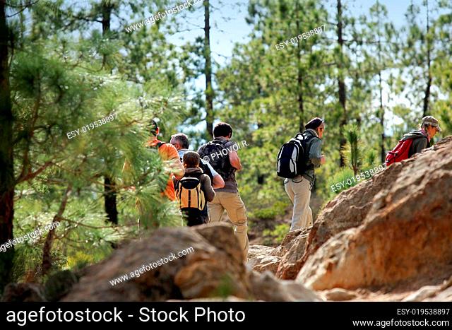 men and women walking with hiking backpack
