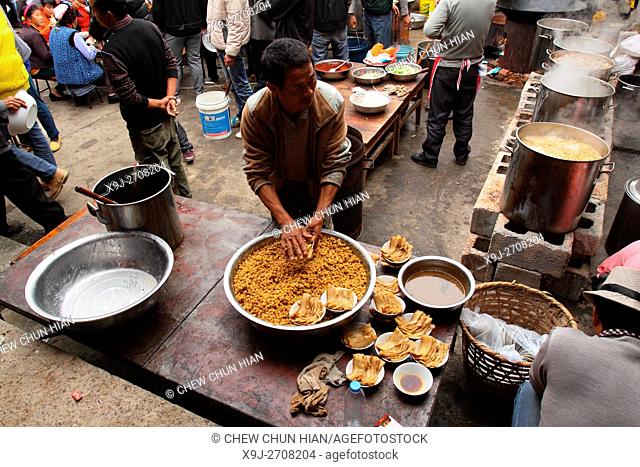 Preparing food for celebration, Bei People's Village in Dali, Yunnan Province, China