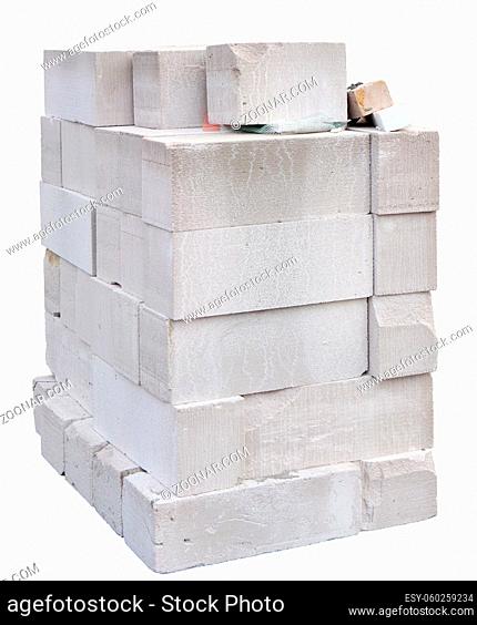 Large white bricks foam concrete blocks heap for the construction of a residential village house. Isolated pn white