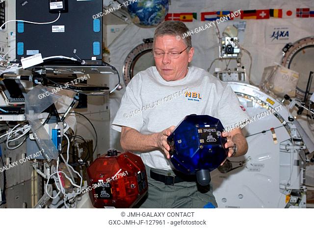 NASA astronaut Mike Fossum, Expedition 29 commander, performs a check on Synchronized Position Hold, Engage, Reorient, Experimental Satellites (SPHERES)...