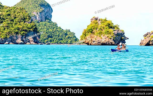 Two women are mother and daughter. Travel by boat with kayak view the beautiful natural landscape of the blue sea and island at summer