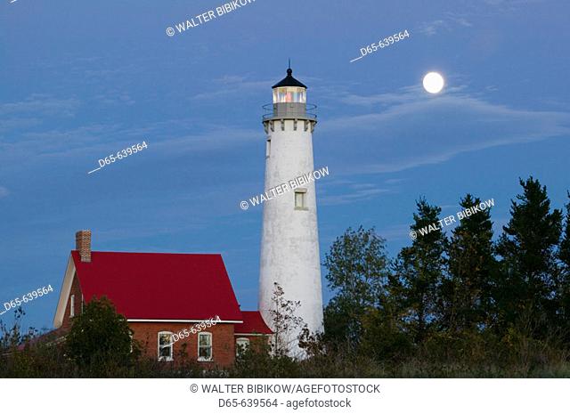 Tawas Point State Park. Tawas Point Lighthouse on Lake Huron. Evening with Moonrise. Tawas City. Michigan. USA