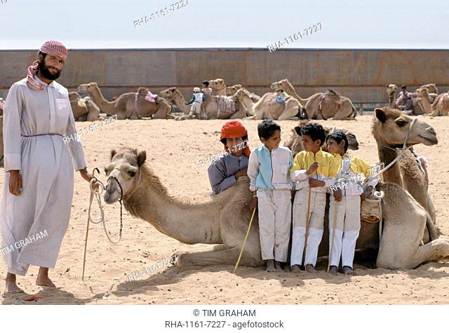 Camel racing with boy jockeys at Al Ain in Abu Dhabi, United Arab Emirates, Middle East