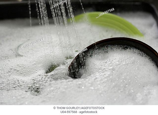 Water spray on dishes in sink
