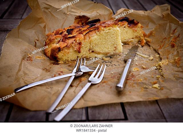 Apple pie on paper with knife and fork