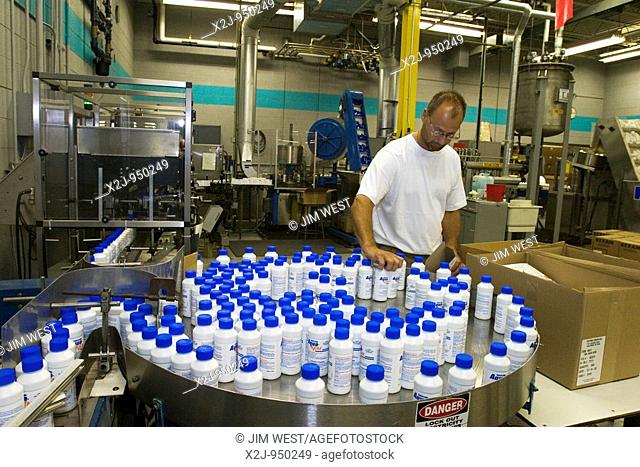 Ann Arbor, Michigan - A worker at Thetford Corporation packages bottles of Aqua-Kem, a chemical deodorant for recreational vehicle toilets  Thetford makes...