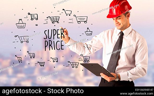 Handsome businessman with helmet drawing SUPER PRICE inscription, contruction sale concept