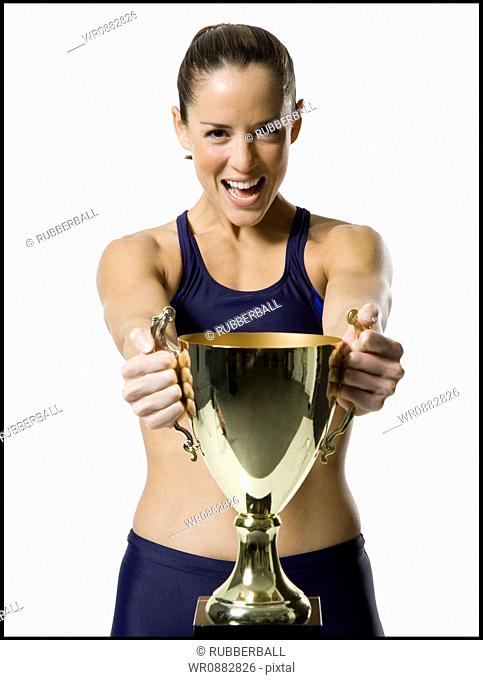 Portrait of a woman holding a trophy