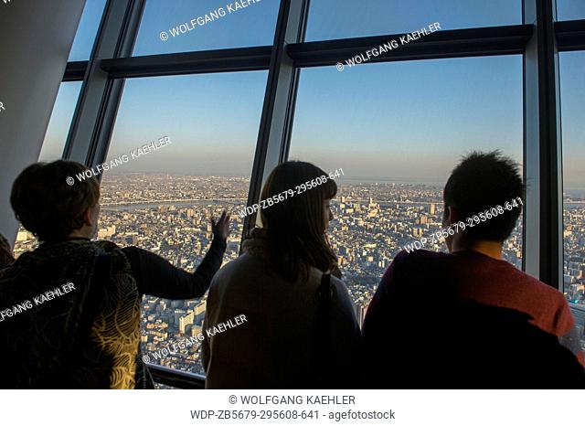 People on the observation deck of the Tokyo Skytree tower, which is the tallest tower in the world and is a broadcasting, restaurant