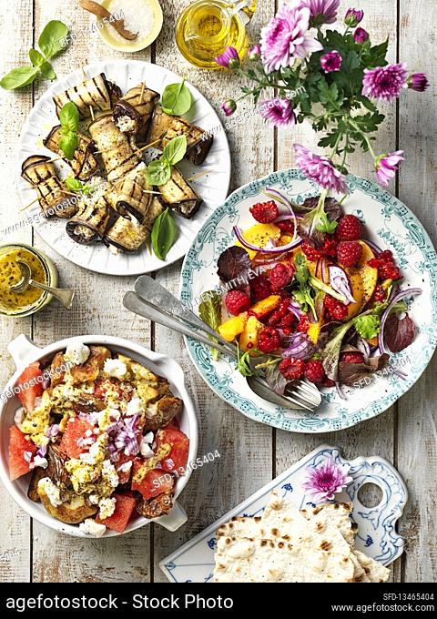 Grilled aubergine rolls with cheese, salad with raspberries, onion and peach, grilled and mashed potatoes with cheese and watermelon