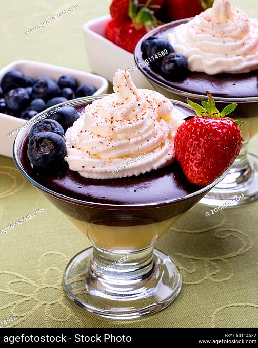 pudding in glass with whipped cream and fruits