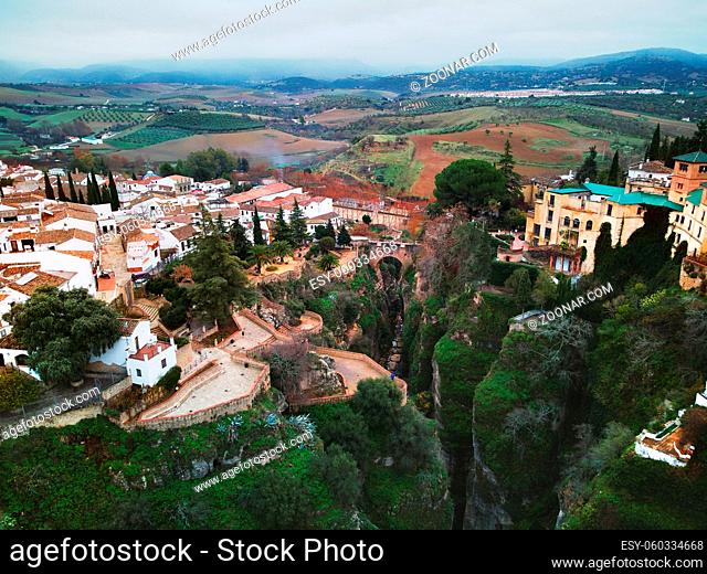 Aerial photography panoramic view from above Ronda spanish city. Stunning canyons residential houses on the edge of cliffs