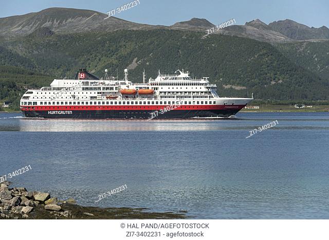 STOKMARKNES, NORWAY - July 08 2019: view of coastal liner cruising in waters of Langoysundet, shot on july 08, 2019 under bright summer light near Stokmarknes