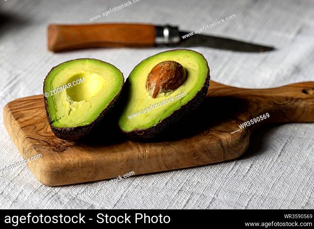 halves of avocado on a board