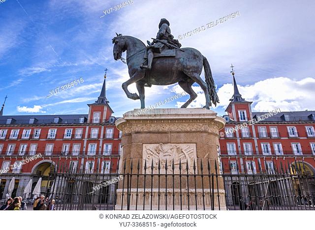King Philip III statue in front of Casa de la Carniceria (Butchery House) municipal and cultural building on Plaza Mayor - Main Square in Madrid, Spain