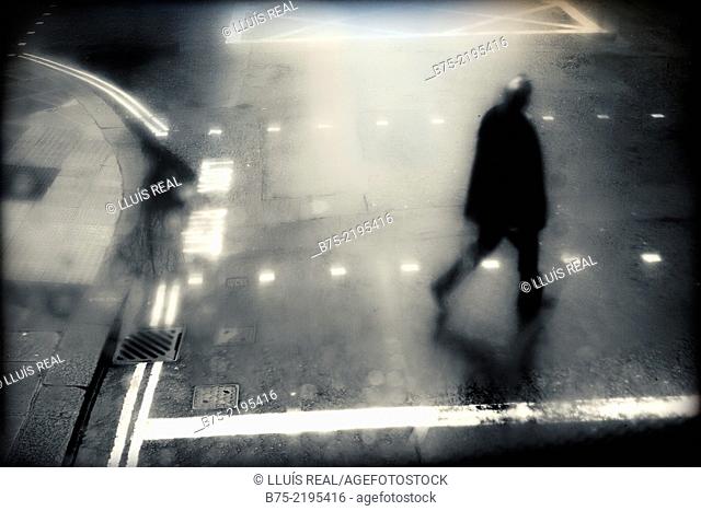 Unrecognizable man crossing the street in the evening in the city of London, England, UK
