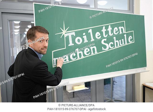 15 October 2018, Berlin: Thilo Panzerbieter, founder and managing director of the ""German Toilet Organization"", writes ""Toiletten machen Schule"" on a...