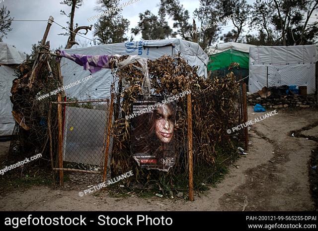 21 January 2020, Greece, Lesbos: A poster of a woman is hanging on a fence in a temporary camp next to the camp in Moria