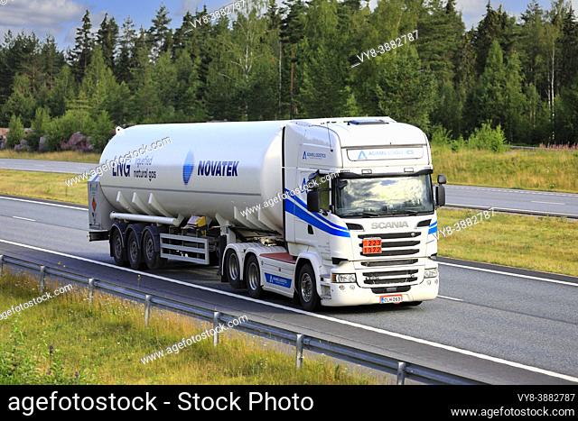 White Scania semi tank truck hauls Novatek LNG, Liquified natural gas, ADR 223-1972, on multiple lane highway. Salo, Finland. July 9, 2021