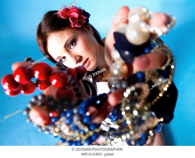 summer girl plenty of jewellery beads in hands