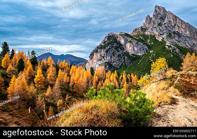Colorful autumn alpine Dolomites rocky mountain scene, Sudtirol, Italy. Peaceful view from Falzarego Pass. Picturesque traveling, seasonal