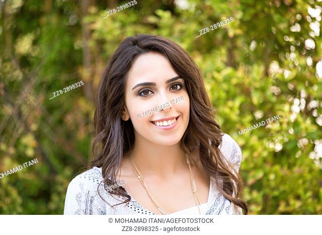 Happy young woman smiling outdoors