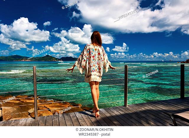 Woman on a beach jetty at Seychelles, La Digue