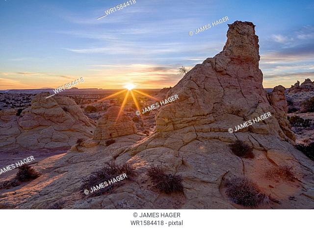 Sandstone formations at first light with a sunburst, Coyote Buttes Wilderness, Vermilion Cliffs National Monument, Arizona, United States of America