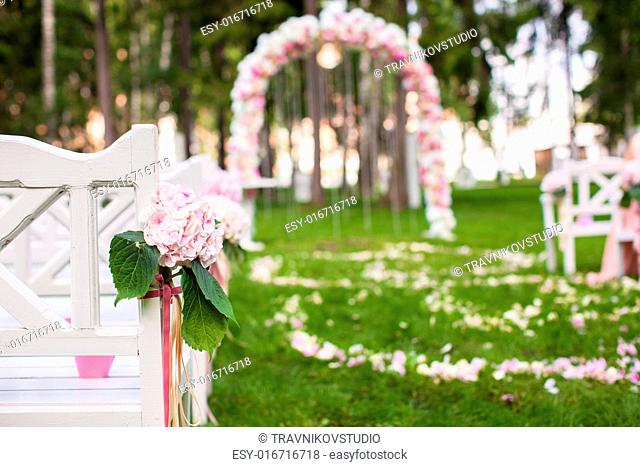 Wedding benches and flower arch for a wedding ceremony outdoors