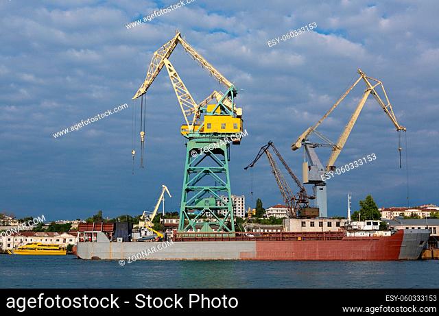 Sevastopol, Russia - June 09, 2016: Lifting cargo cranes at the shipyard in Bay of Black Sea