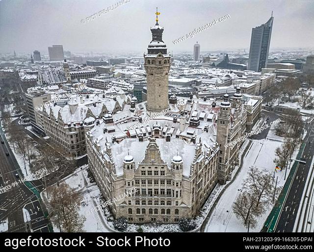 03 December 2023, Saxony, Leipzig: Snow lies on the tower and roofs of the New Town Hall. However, the winter magic is not expected to last much longer
