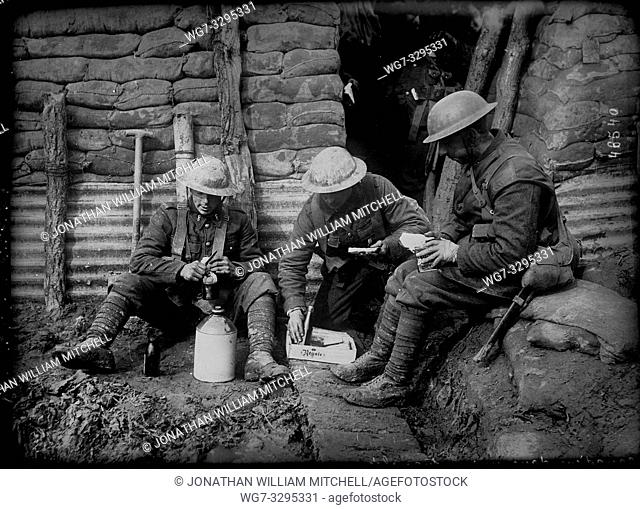 BELGIUM Western Front -- circa 1915 -- Canadian soldiers sit and eat their lunch in a muddy trench on the Western Front in Flanders Belgium during World War I...