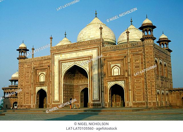 Taj Mahal palace grounds. False mosque building. Dome, red sandstone brick. Inlaid tiles, decorations