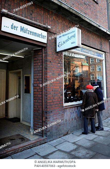 Two passersby look into the shop window of the cap shop Eisenberg in Hamburg, Germany, 15 March 2013. Since 1892 the cap shop Eisenberg produces and sells caps...