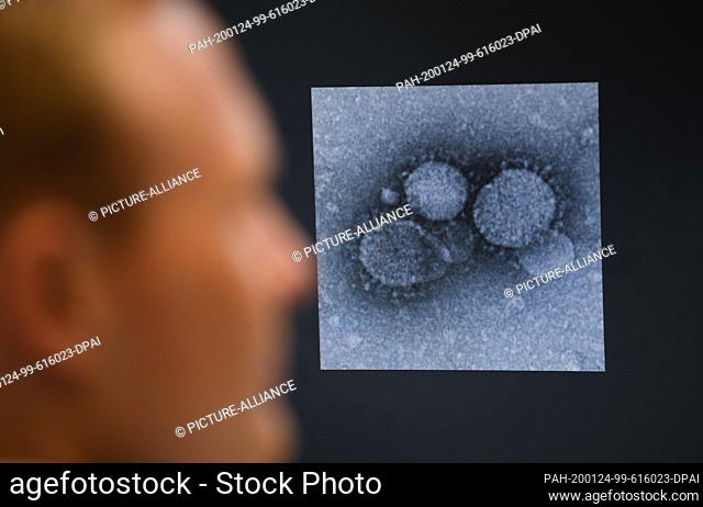 24 January 2020, Hessen, Marburg: Virologist Sandro Halbe is looking at an electron microscope image of a MERS coronavirus