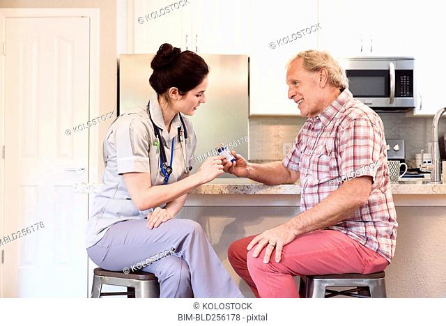 Caucasian nurse explaining prescription to man