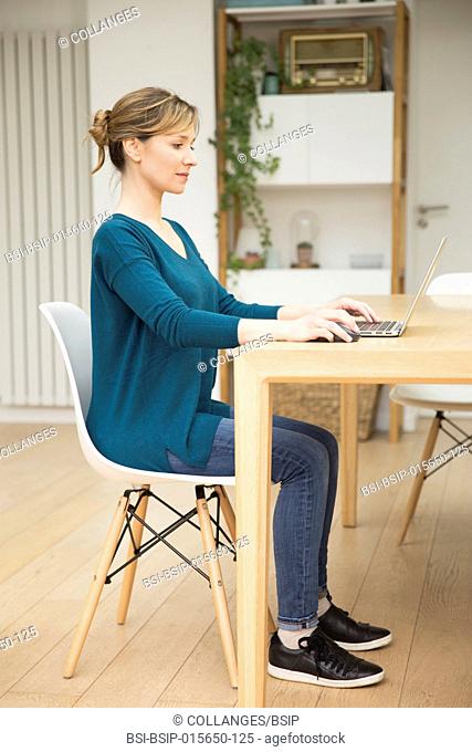 Woman using laptop. Correct seated posture