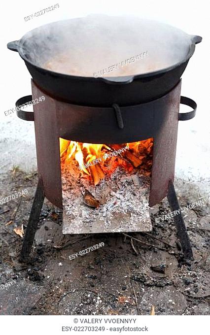 cooking stew on outdoor mobile brazier