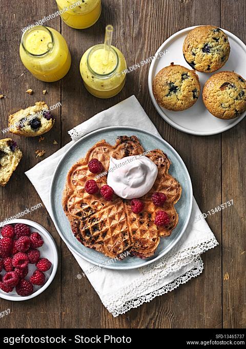 Waffels chith chocolate, raspberries and whipped cream. Muffins and smoothie