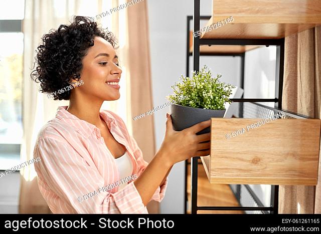 woman decorating home with flower or houseplant