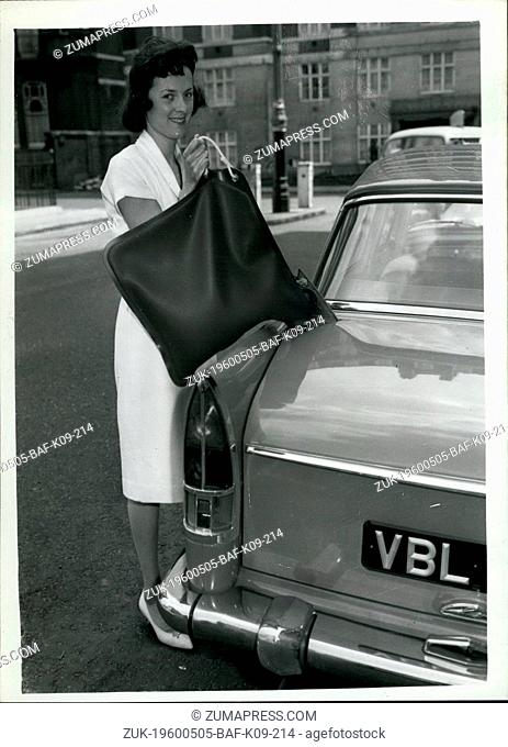 May 05, 1960 - New uses for nylon container for Petrol; Yvonne Mintrans of Fawley, Hants demonstrates a new liquid container - which holds four gallons of...